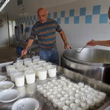 Productie van ricotta. De ricotta wordt van de gekookte wei afgeschept.